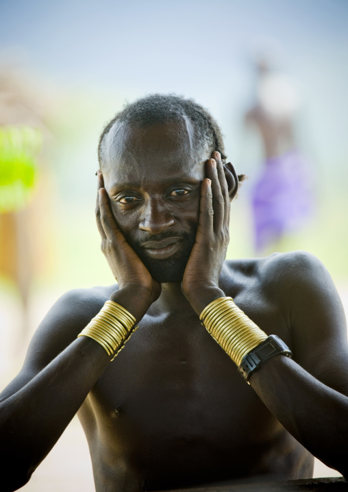 Portrait Of A Karo Tribe Man With Golden Bracelets Holding His Head, Korcho Village, Ethiopia