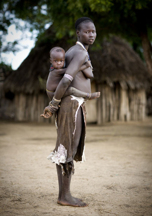 Portrait Of A Karo Tribe Mother Carrying Her Kid In Her Back, Korcho Village, Ethiopia