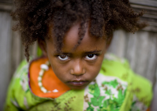 Portrait of a serious dorze tribe girl with wild hair, Chencha, Omo valley, Ethiopia