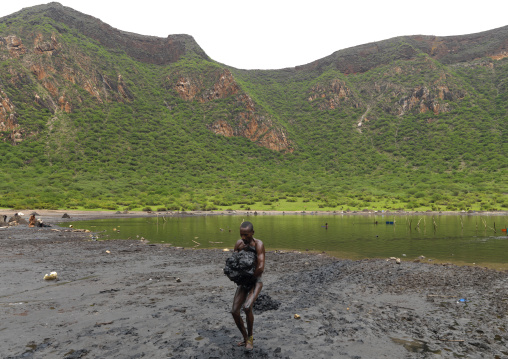 Borana Tribe Man Carrying Salt Taken From The Lake Of El Sod Volcano, Yabello, Omo Valley, Ethiopia