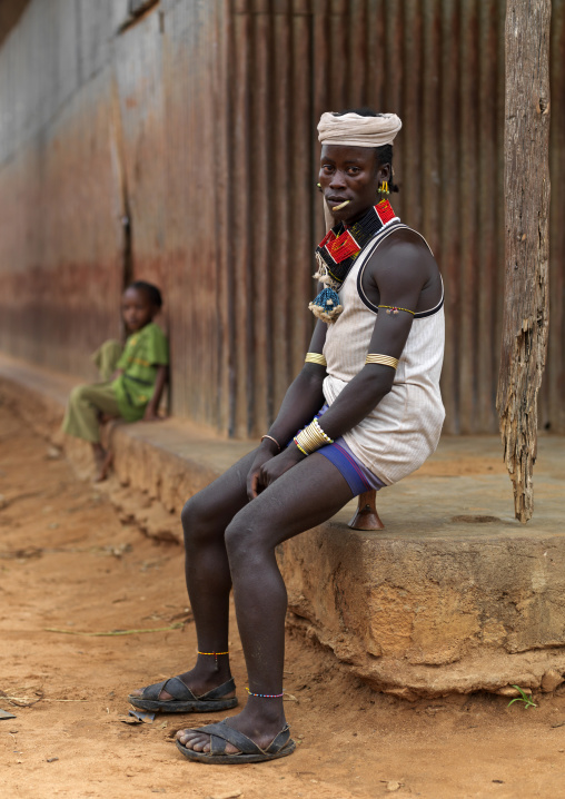 Hamar Tribe Man With Turban, Necklaces And Bracelets Sitting On His Headrest, Turmi, Omo Valley, Ethiopia