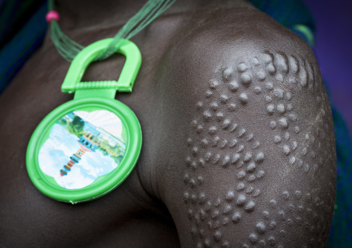Scarifications and decoration on a Suri tribe man, Kibish, Omo valley, Ethiopia