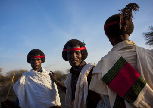Smiling Karrayyu Adult Men With Their Gunfura Traditional Hairstyle And A Red Headband In Gadaaa Ceremony, Metehara, Ethiopia