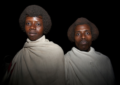 Night Shot Of Smiling Karrayyu Men With Their Gunfura Traditional Hairstyle In Gadaaa Ceremony, Metehara, Ethiopia