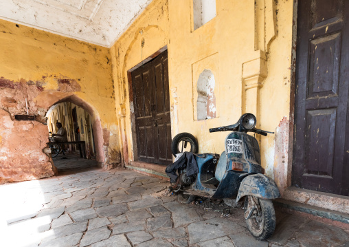 Old scooter parked in front of a wooden door, Rajasthan, Jaipur, India