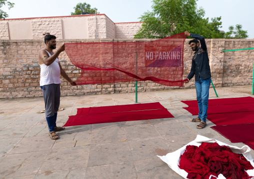 Indian men drying a sari in the street, Rajasthan, Jodhpur, India
