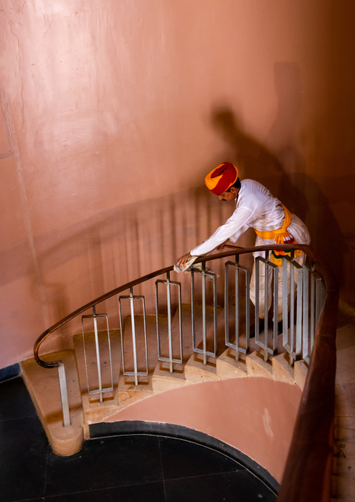 Portrait of a rajasthani man in traditional clothing cleaning stairs, Rajasthan, Jodhpur, India