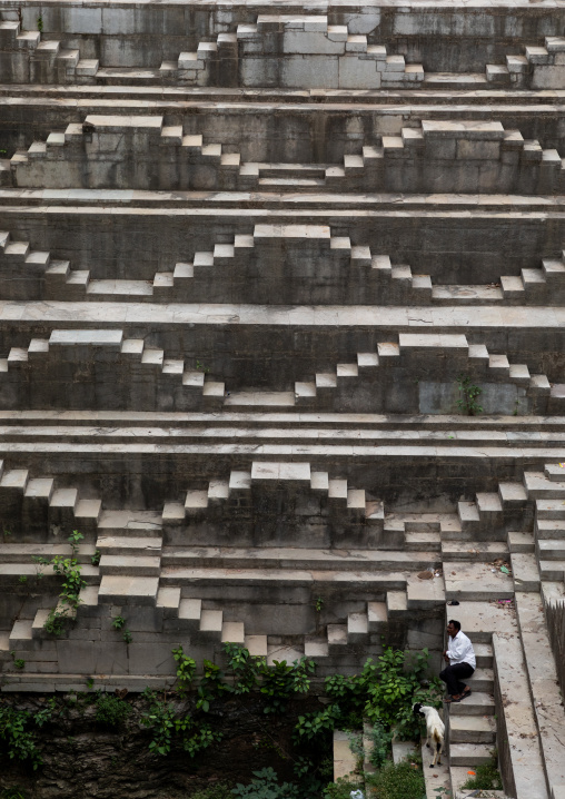 Indian man with his goat in dhabhai ka Kund stepwell, Rajasthan, Bundi, India