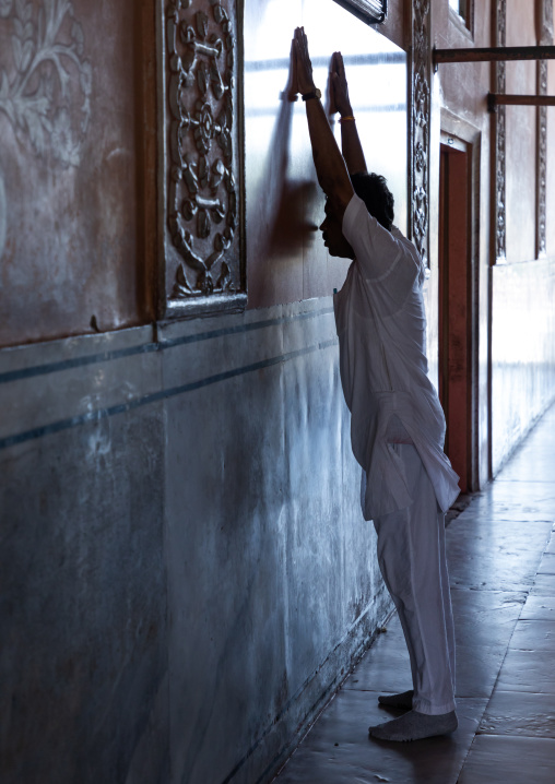 Indian man praying in a temple, Rajasthan, Jaipur, India