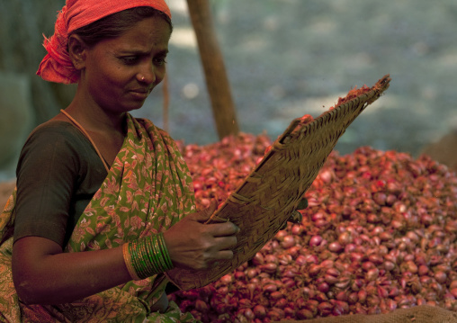 Red Onions Seller Holding A Wicker Tray At The Madurai Market, India