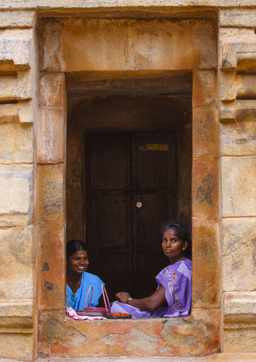 Young Amused Woman Sitting At A Cut In Rock Window At The Brihadishwara Temple, Thanjavur,india