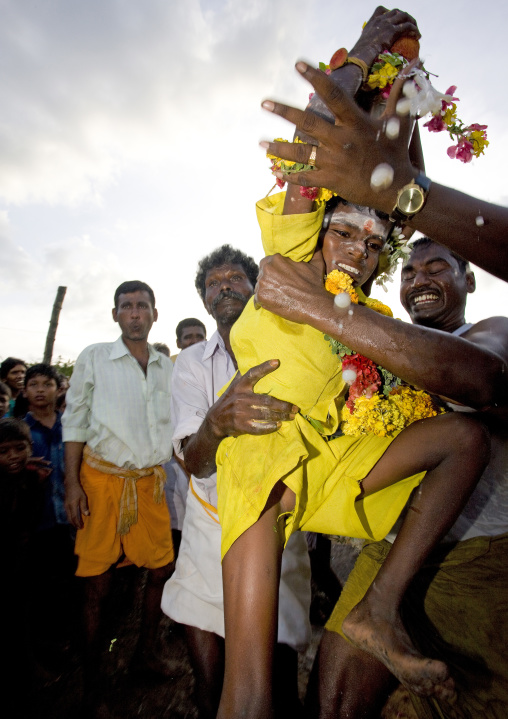 Little Boy With Yellow Clothes Carried By Men Succeeding At Fire Walking In Tamil Nadu, Madurai, South India