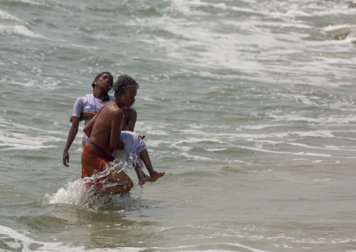 Woman Going Into The Sea For Purification During Theyyam Ceremony, Thalassery, India