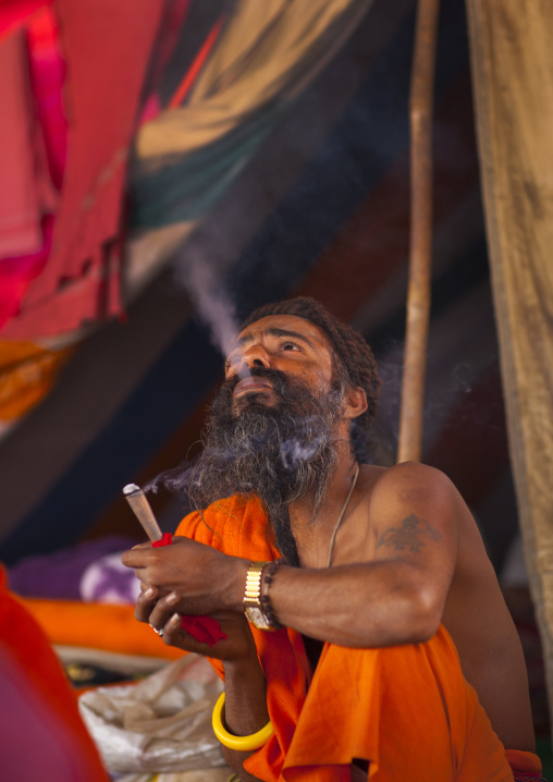 A Naga Sadhu Smoking Pot, Maha Kumbh Mela, Allahabad, India