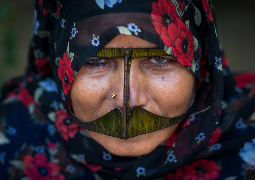 a bandari woman wearing a traditional mask called the burqa with a moustache shape, Qeshm Island, Salakh, Iran