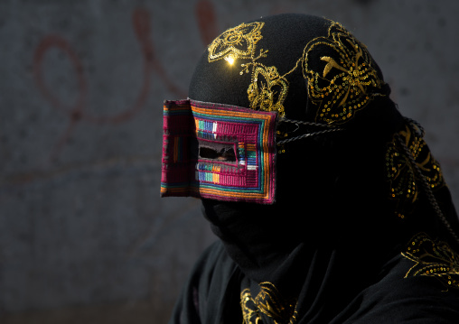 a bandari woman wearing the traditional mask called the burqa on a market, Hormozgan, Bandar Abbas, Iran
