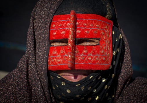 a bandari woman wearing the traditional mask called the burqa on a market, Hormozgan, Bandar Abbas, Iran