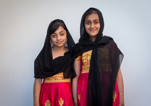portrait of two young girls in traditional bandari clothing during a ceremony, Hormozgan, Bandar-e Kong, Iran