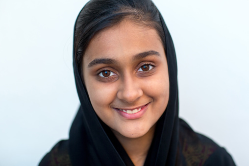 portrait of a young smiling girl in traditional bandari clothing during a wedding ceremony, Hormozgan, Bandar-e Kong, Iran