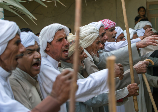 men dancing with sticks during a wedding ceremony, Qeshm Island, Salakh, Iran