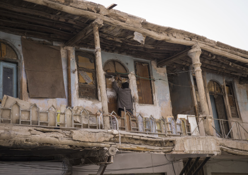 Man closing the door of his old house, Isfahan province, Isfahan, Iran