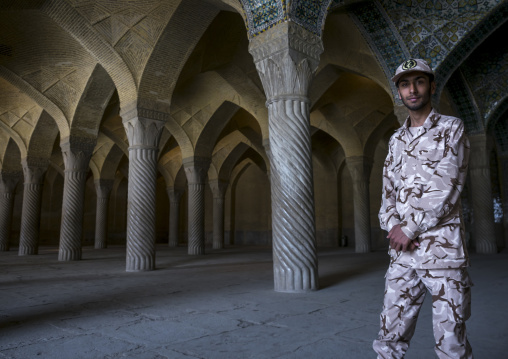 Soldier inside vakil mosque prayer hall, Fars province, Shiraz, Iran