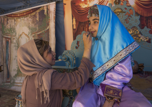 Girl pausing in traditional clothing for a photo souvenir in the saadabad palace, Shemiranat county, Tehran, Iran