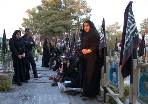 Families praying on the tomb of their sons killed in the Iran Iraq war in the Rose garden of martyrs cemetery, Isfahan Province, Isfahan, Iran