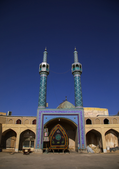 A nakhl and an alam made of clothes in front of a mosque during Muharram to commemorate the martyrdom anniversary of Hussein, Yazd Province, Yazd, Iran