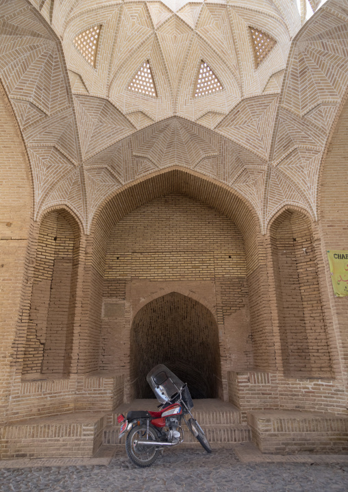 Motorbike in front of the entrance of a water reservoir, Yazd Province, Meybod, Iran