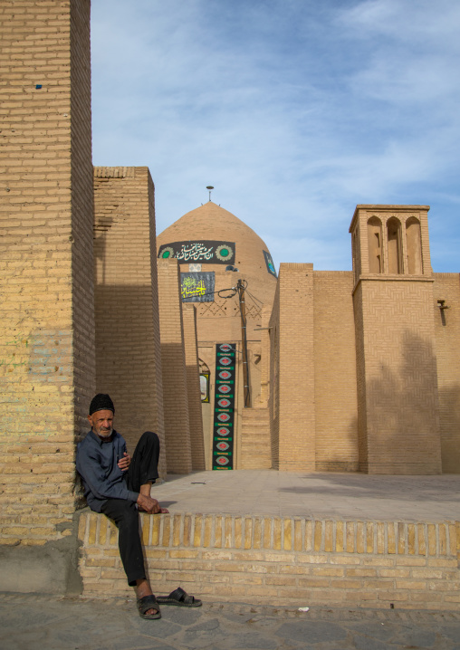 Old man sit in front of the Jame mosque, Isfahan Province, Nain, Iran
