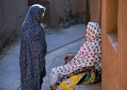 Iranian women wearing traditional floreal chadors in zoroastrian village, Natanz County, Abyaneh, Iran