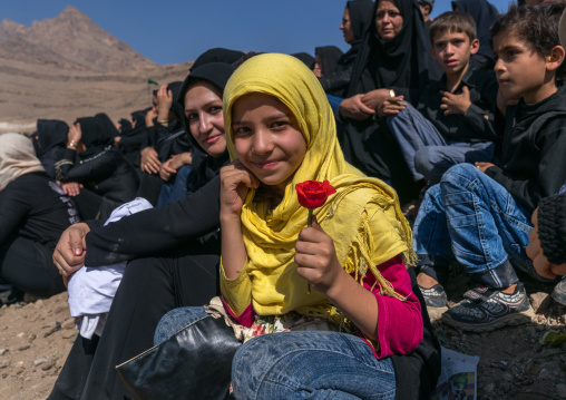Iranian girl with a rose during a traditional religious theatre called tazieh about Imam Hussein death in Kerbala, Lorestan Province, Khorramabad, Iran