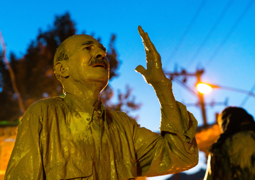 Iranian shiite muslim man crying after rubbing mud on his body during the Kharrah Mali ritual to mark the Ashura ceremony, Lorestan Province, Khorramabad, Iran