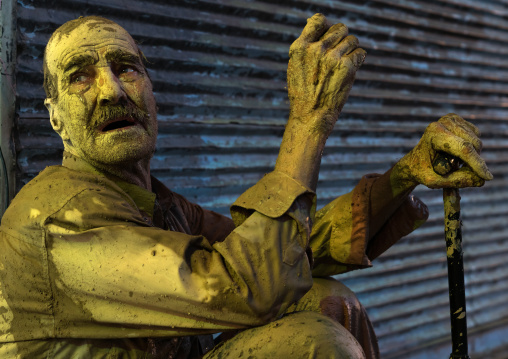 Iranian shiite muslim man crying after rubbing mud on his body during the Kharrah Mali ritual to mark the Ashura ceremony, Lorestan Province, Khorramabad, Iran