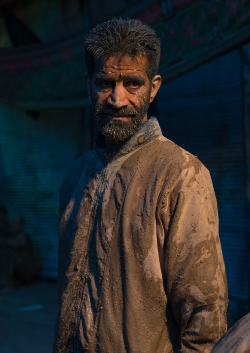 Iranian shiite muslim man after rubbing mud on his body during the Kharrah Mali ritual to mark the Ashura ceremony, Lorestan Province, Khorramabad, Iran