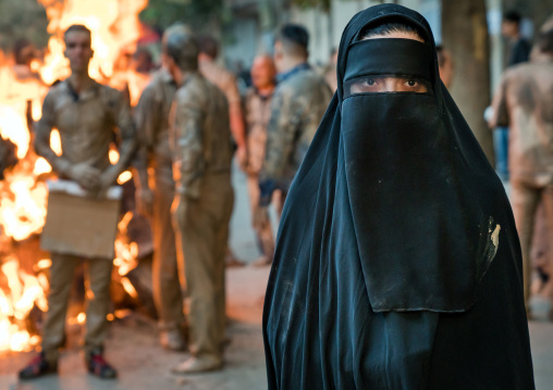 Iranian shiite muslim woman after rubbing mud on her chador during the Kharrah Mali ritual to mark the Ashura ceremony, Lorestan Province, Khorramabad, Iran
