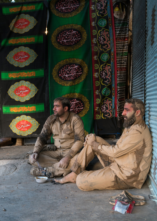 Iranian shiite muslim men with mud stains during the Ashura day, Lorestan Province, Khorramabad, Iran