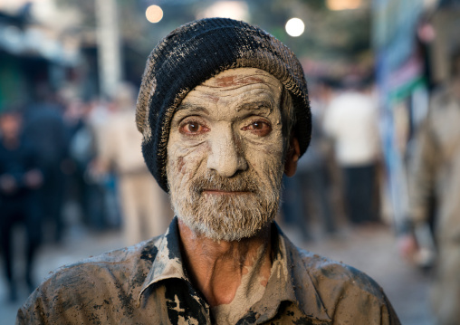 Iranian shiite muslim man after rubbing mud on his body during the Kharrah Mali ritual to mark the Ashura ceremony, Lorestan Province, Khorramabad, Iran