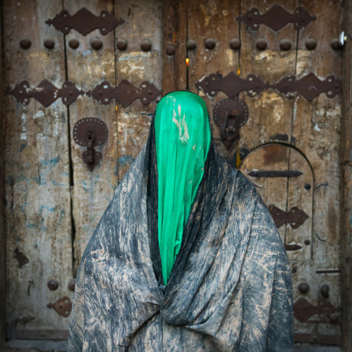 Iranian shiite muslim woman after rubbing mud on her chador during the Kharrah Mali ritual to mark the Ashura ceremony, Lorestan Province, Khorramabad, Iran