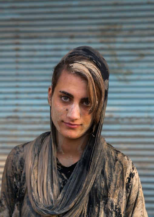 Iranian shiite muslim woman after rubbing mud on her chador during the Kharrah Mali ritual to mark the Ashura ceremony, Lorestan Province, Khorramabad, Iran