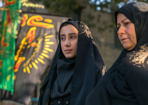 Iranian shiite muslim women with mud stains on their chadors during the Ashura ceremony, Lorestan Province, Khorramabad, Iran