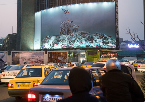 parody of raising the flag on iwo jima historic picture on valiasr square showing american marines on dead bodies, Central district, Tehran, Iran
