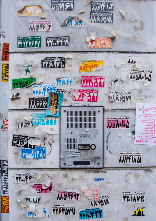 doorway full of advertising stickers, Central district, Tehran, Iran