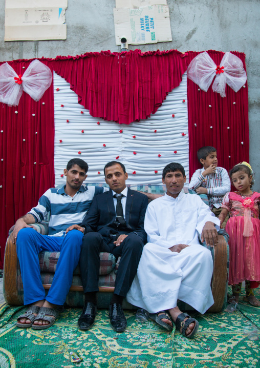 groom posing with his relatives during a wedding ceremony, Qeshm Island, Salakh, Iran