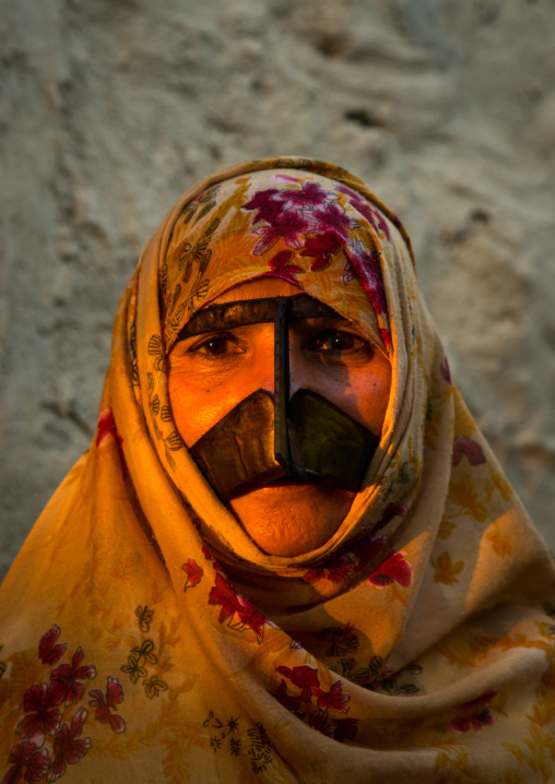 a bandari woman wearing a traditional mask called the burqa with a moustache shape, Qeshm Island, Salakh, Iran