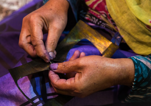 a bandari woman sewing a traditional burqa mask, Qeshm Island, Salakh, Iran