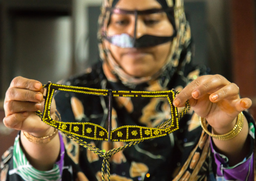 a bandari woman wearing a traditional mask called the burqa with a moustache shape, Qeshm Island, Salakh, Iran