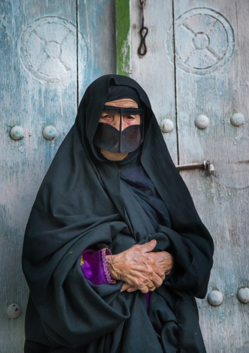 an old bandari woman wearing a traditional mask called the burqa, Qeshm Island, Salakh, Iran