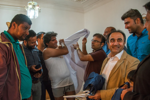 groom putting his new clothes for the wedding ceremony, Hormozgan, Kushkenar, Iran